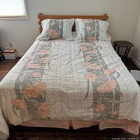 Bed fully made showing frame, mattress, comforter, pillowcases, bed skirt