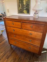 Front view of solid wood dresser showing drawer layout and hardware