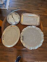 Group shot of the four sterling silver trays on table