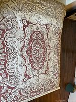 Full view of unfolded lace tablecloth showing overall pattern and coloration