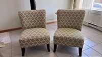 Front view of both sage green trellis slipper chairs