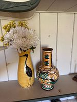 Both vases side by side on shelf, showing overall form and colours