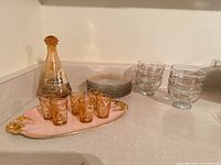 Full lot showing decanter, shot glasses on tray, plates stack and bowls