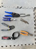 Overview of seven tools laid out on mat
