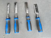 Four Mastercraft chisels with blue/black handles