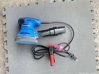 Full view of Mastercraft blue random orbit sander showing power cord and dust port