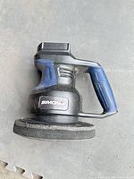 Profile view of Simoniz cordless polisher/buffer showing handle, body and attached foam pad