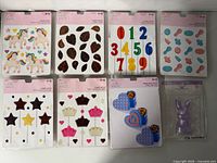 Eight packaged candy molds laid out