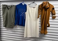 Group shot of all four garments hanging: shorts, hoodie, dress, Scooby-Doo costume