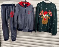 Nike sweatpants, Nike hoodie and Jake Austin sweater hung side by side