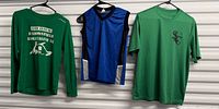 Overview of three shirts hanging on wall