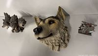 Group shot of wolf head plaque, twin wolf figurine, metal dragon figurine