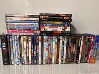 Full view of approximately 60 DVDs in two rows