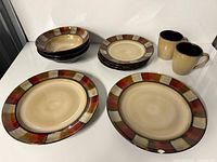 Full dinnerware set showing plates, bowls and mugs