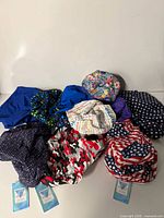 Group shot of all nine new scrub caps with tags