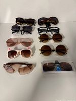 Overall view of all nine eyewear pieces arranged in three rows