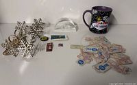 Overview of all items including napkin rings, mug, paperweight, button, stamps and tickets