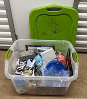 Overall view of contents in transparent bin with lid behind