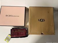 BCBGeneration shoe box, UGG shoe box, Travelon wallet in tray