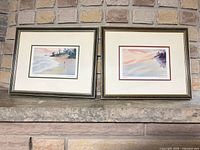 Front view of both framed prints on mantel