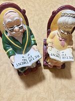 Both ceramic piggy bank figurines front view