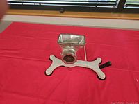 Top view of manual meat grinder assembled on white suction base