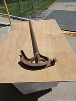 full view of conduit bender on plywood surface