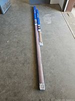 Two long blue Coolaroo boxes lying on floor