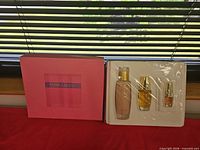 Gift set box and inner tray with three sealed perfume bottles