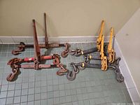 Group of six lever load binders showing color variations and attached chain segments