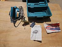 Makita planer, case, fence, manuals, accessories laid out