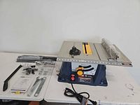 full view of Ryobi table saw with accessories laid out