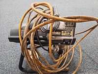 front view of sprayer showing model label and hose coiled