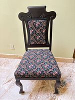 Front view of dark wood side chair with floral upholstered seat and back