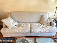 Front view of beige pinstripe Baker sofa with cushions and pillows