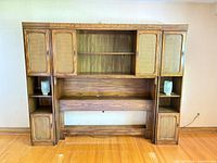 Full view of wood headboard unit with shelves and lamps