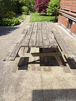 Full view of wooden picnic table showing both benches and A-frame legs