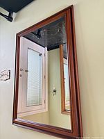 Full front view of rectangular wall mirror mounted on wall
