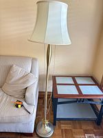 Full view of floor lamp next to sofa and table