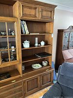 Front view showing shelves, glass doors, drawers, lower cabinets