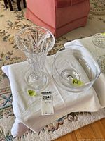 Cut crystal vase and clear glass bowl on table