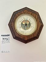 Full view of octagonal wood frame barometer with dial visible