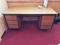 Front view of wood veneer desk with six drawers
