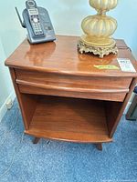 Front and top view of nightstand showing telephone and lamp (not included)