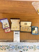 Overview of all boxed and loose dress accessories on surface