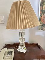 Full view of lamp with shade on table showing height and style