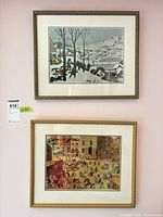 Both framed prints displayed on wall