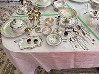 overview of mixed silver-plate items on table