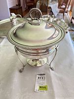Overall view of chafing dish with lid on stand