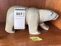 Full left side view of soapstone bear sculpture